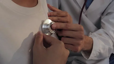 Doctor using a stethoscope to examine a female patient's chest. Medical che.. Stock Footage 340539418