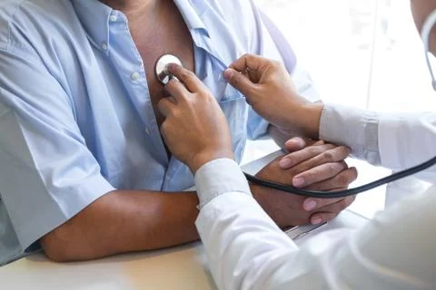 Doctor using stethoscope to listen checking Heart rate measuring to a patient Stock Photos