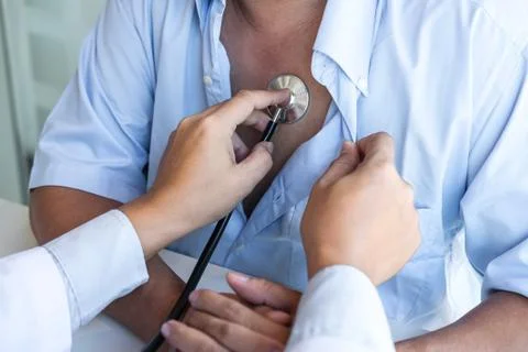 Doctor using stethoscope to listen checking Heart rate measuring to a patient Stock Photos