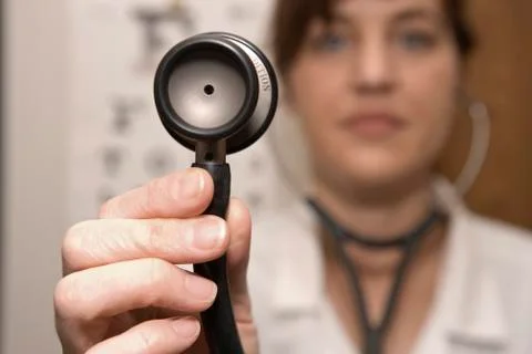 A doctor using a stethoscope Stock Photos