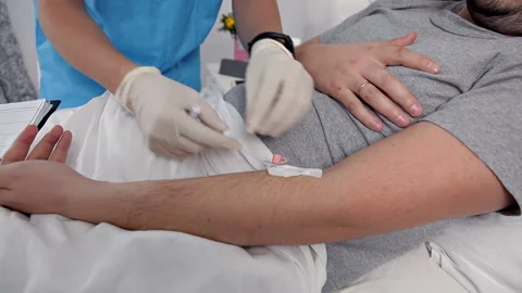 Doctor using syringe to make injection of vaccine to patient in hospital.The man Stock Footage 100042511