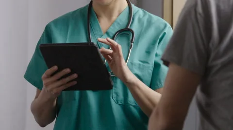 Doctor using a tablet,  consulting with senior patient 動画素材 63010285