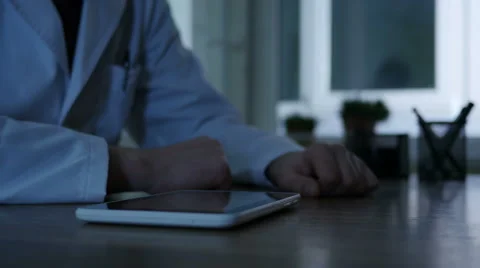 Doctor Using Tablet Pc At Night Stock Footage 64061491