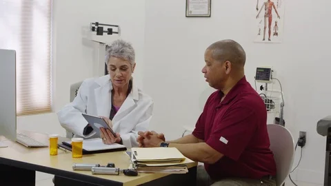 Doctor using tablet to speak with patient Stock Footage 80129186