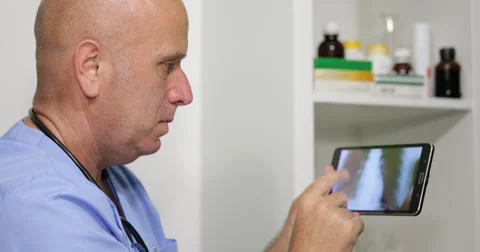 Doctor Using Tablet Technology Looking Patient Radiography Serious  Disappointed 스톡 동영상 55337811