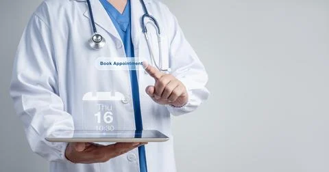 Doctor using tablet with virtual appointment booking and calendar interface.. Stock Photos