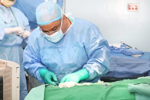 Doctor using tools in a surgery Stock Photos