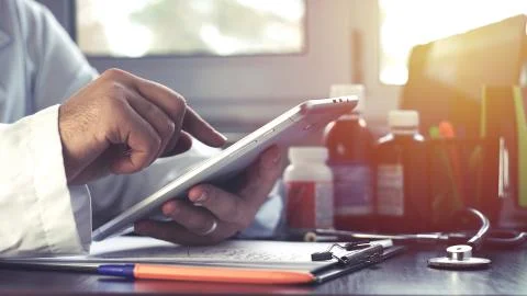 Doctor using touchscreen tablet Close Up shot Stock Photos