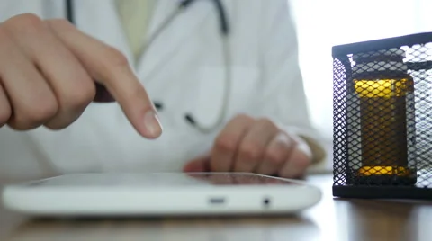 Doctor Using Touchscreen On Tablet Stock-Footage 64063600
