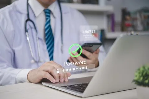 Doctor using two factor authentication on laptop with OTP code and password.. Stock Photos