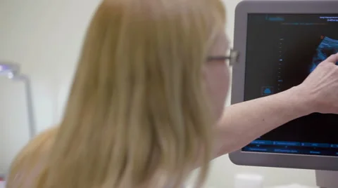 Doctor is using ultrasound machine to scan 스톡 동영상 63572898