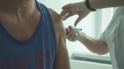 The doctor vaccinates the man. Stock Footage 157328295