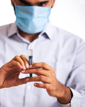 Doctor with vaccine and syringe Stock Photos