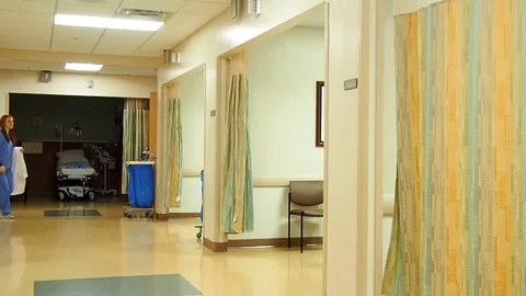 Doctor walking down hallway Stock Footage 70685968