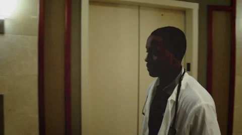 Doctor walking into an elevator Stock Footage 36250362