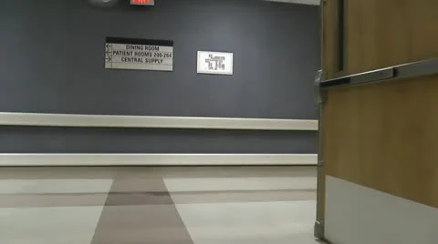 Doctor Walks Through Hospital Hallways ED Stock Footage