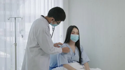 The doctor was using a stethoscope to check the patient's pulse Stock Footage 149704885
