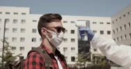 Doctor Wearing Mask Remotely Measures Temperature Student Using Thermometer. Stock Footage