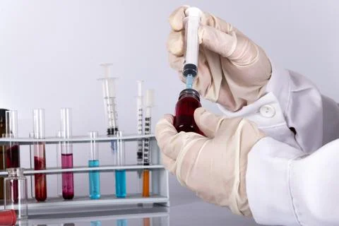 Doctor while analyzing a flu vaccine Stock Photos