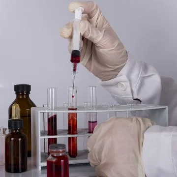 Doctor while analyzing a flu vaccine Stock Photos