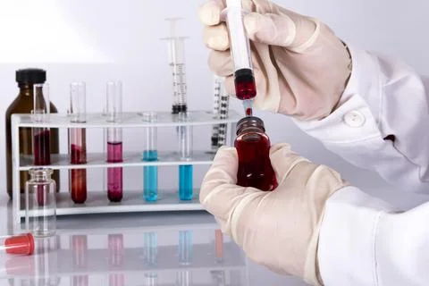 Doctor while analyzing a flu vaccine Stock Photos
