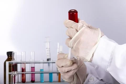 Doctor while analyzing a flu vaccine Stock Photos