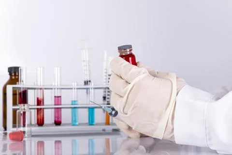 Doctor while analyzing a flu vaccine Stock Photos