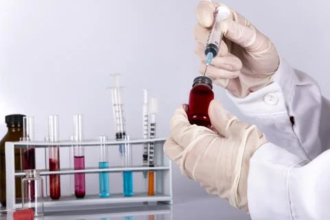 Doctor while analyzing a flu vaccine Stock Photos