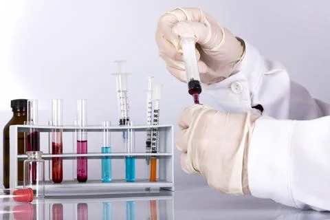 Doctor while analyzing a flu vaccine Stock Photos