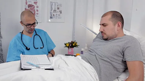 The doctor, while in the patients ward, puts on medical gloves on his hands Stock Footage 100041825