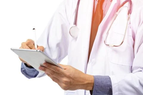 Doctor in white uniform using tablet computer with stethoscope . Stock Photos