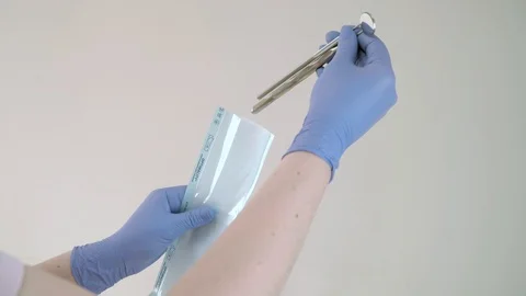 The doctor will put dental instruments for sterilization in a steam autoclave Stock Footage 104509287