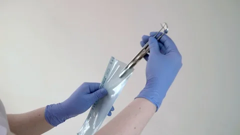 The doctor will put dental instruments for sterilization in a steam autoclave Stock Footage 104509340