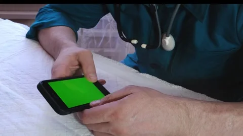 The doctor will scroll on the phone screen Stock Footage 240928374