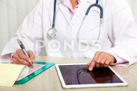 Doctor woman hands with tablet computer. Stock Photos