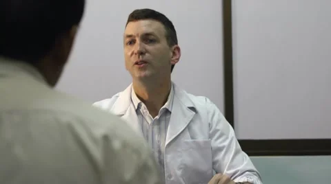 Doctor working and talking to old sick man in clinic Video stock 10688058