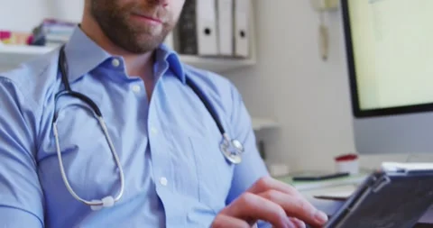 Doctor working and using digital tablet in a retirement home Stock Footage 341319495