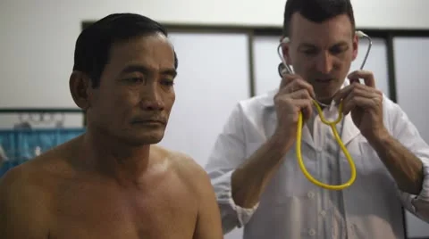 Doctor working and visiting old sick man in clinic Stock Footage 10688097