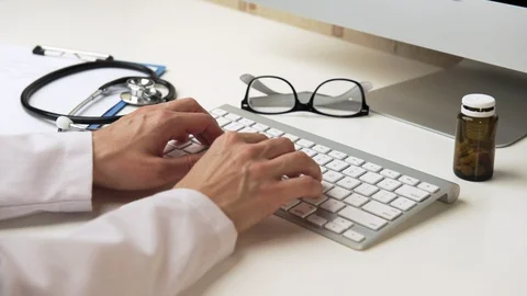 Doctor working at computer Stock Footage 93333821