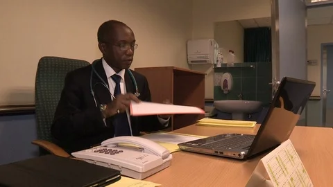 Doctor working at computer in office Video stock 91979256