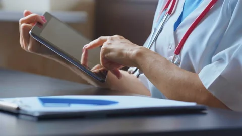 Doctor working on a digital tablet with copy space Stock Footage 94986938