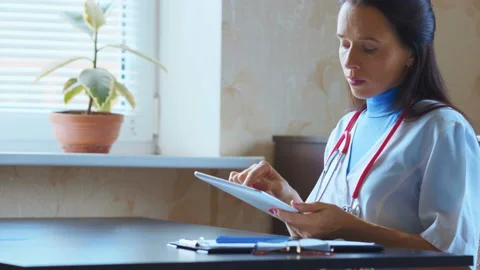 Doctor working on a digital tablet with copy space Stock Footage 94987549