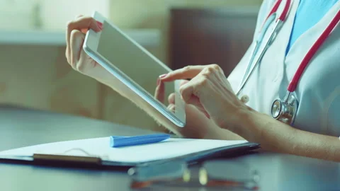 Doctor working on a digital tablet with copy space Stock Footage 94987709