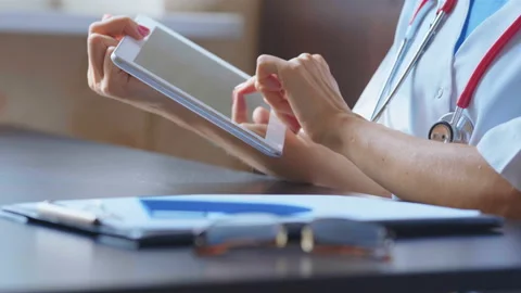 Doctor working on a digital tablet with copy space Stock Footage 94988785