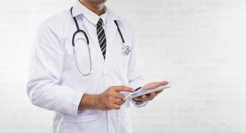 Doctor working on a digital tablet isolated on white background. Doctor in .. Foto stock