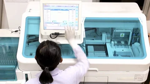 Doctor working in a laboratory on a modern machine for blood testing Stock Footage 60793903