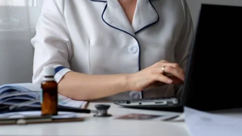 Doctor Working with Laptop and Documents Stock Footage 88321752