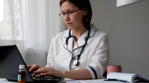 Doctor Working with Laptop and Documents Video stock 88321935