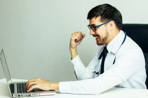 Doctor is working with laptop in his medical office,Community Health and Deve Stock Photos
