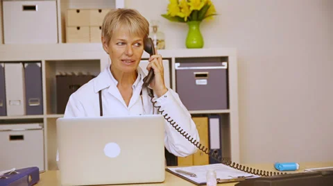 Doctor working in office and getting phone call Stock Footage 34626728